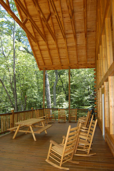 Huge covered upper deck with picnic table, grill and rocking chairs