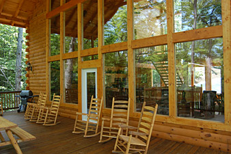 spacious deck with picnic table and rocking chairs