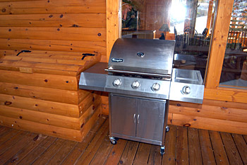 Huge covered upper deck with picnic table, grill and rocking chairs